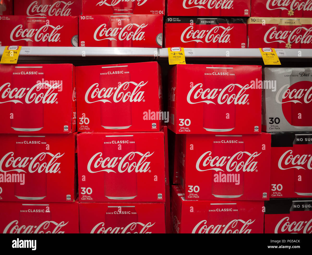 Many boxes of Coca Cola on supermarket shelves for customers to choose. Melbourne, VIC Australia. Stock Photo