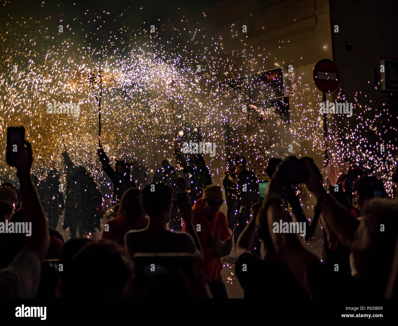 Barcelona, Spain. August 22, 2018 - People celebrating in the Fire Run 'Correfoc' ritual in Gracia Festival in Barcelona Stock Photo