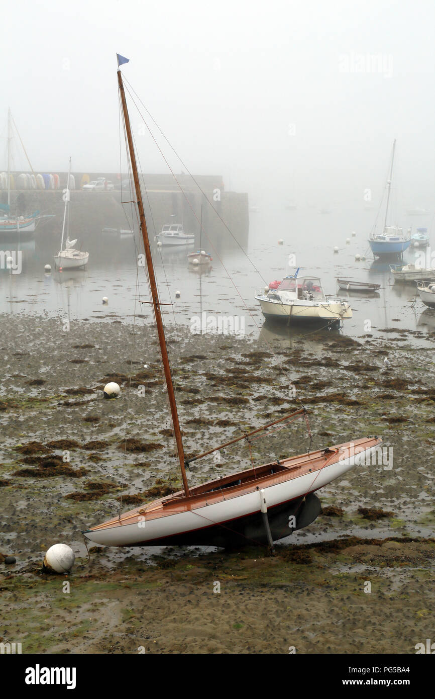Sailing boat moored at low tide in marina at Quai Charles de Gaulle, Roscoff, Finistere, Brittany, France Stock Photo
