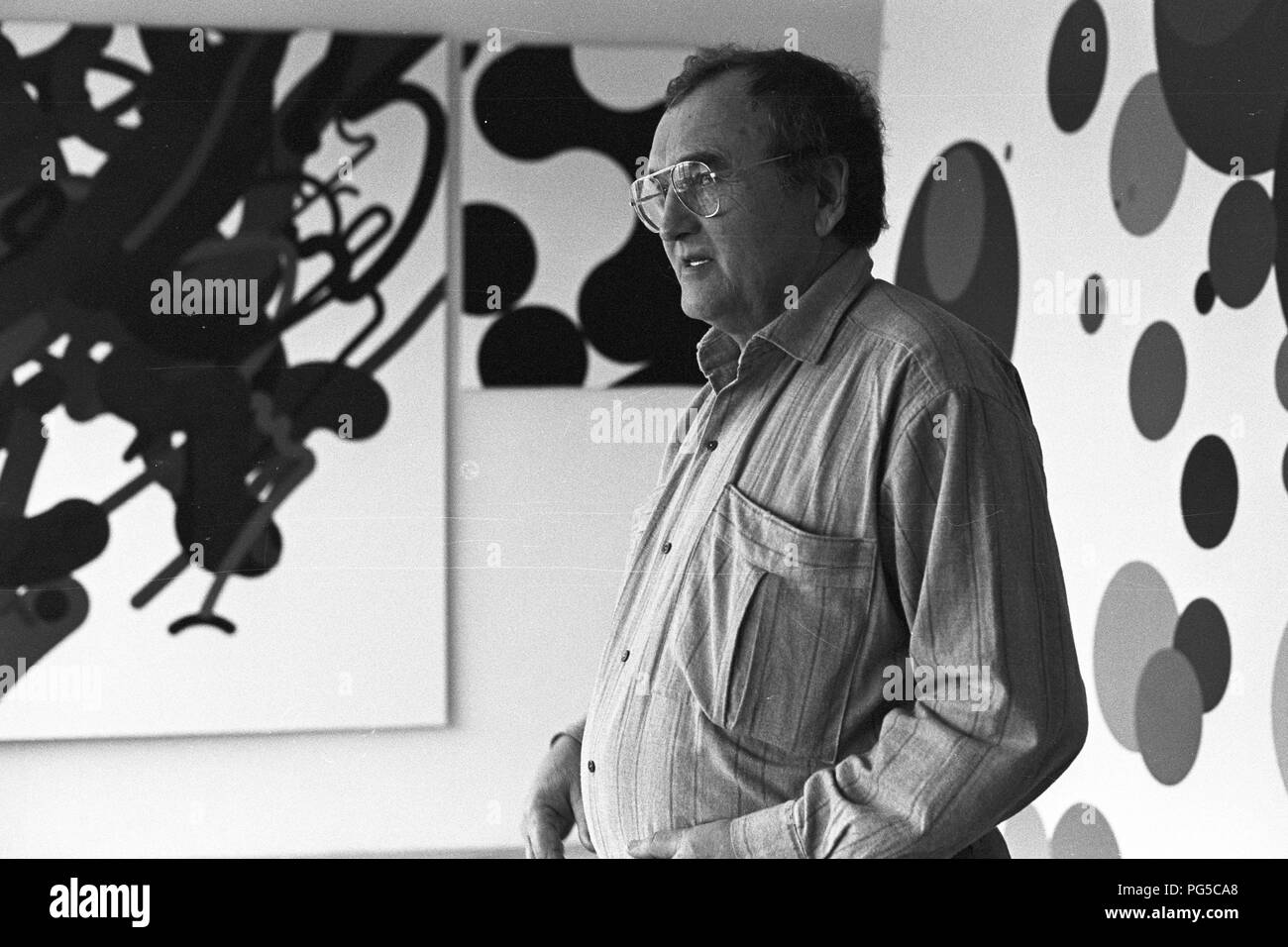 The Czech painter Zdenek Sykora in his studio in Louny. Sykora used a computer for the composition arrangements of his paintings, which he then transferred to the canvas in acrylic. From 1966 he was a lecturer at the Charles University in Prague. Stock Photo