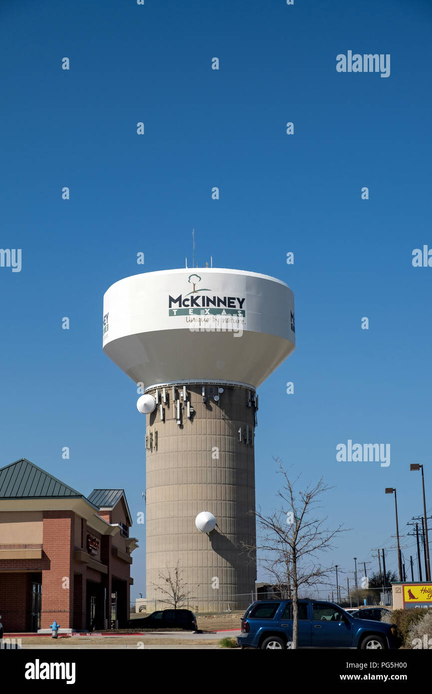 Iconic Water Tower of McKinney, Texas, a suburb of Dallas-Fort Worth. Branded with “Unique by Nature”. Blue sky, copy space, no people, vertical. Stock Photo
