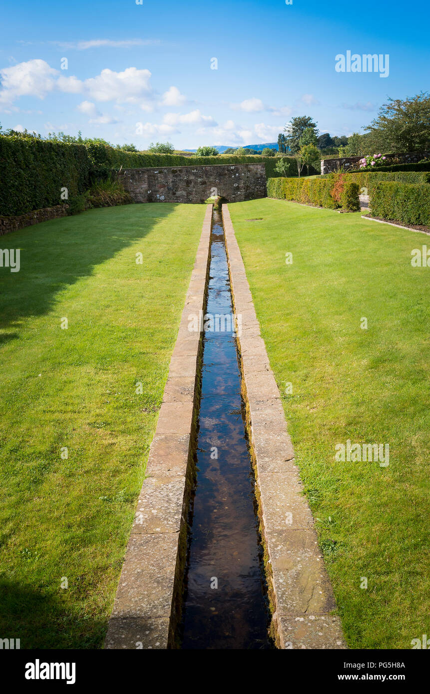 A linear rill water feature in the garden at Blencowe Hall in Cumbria England UK Stock Photo