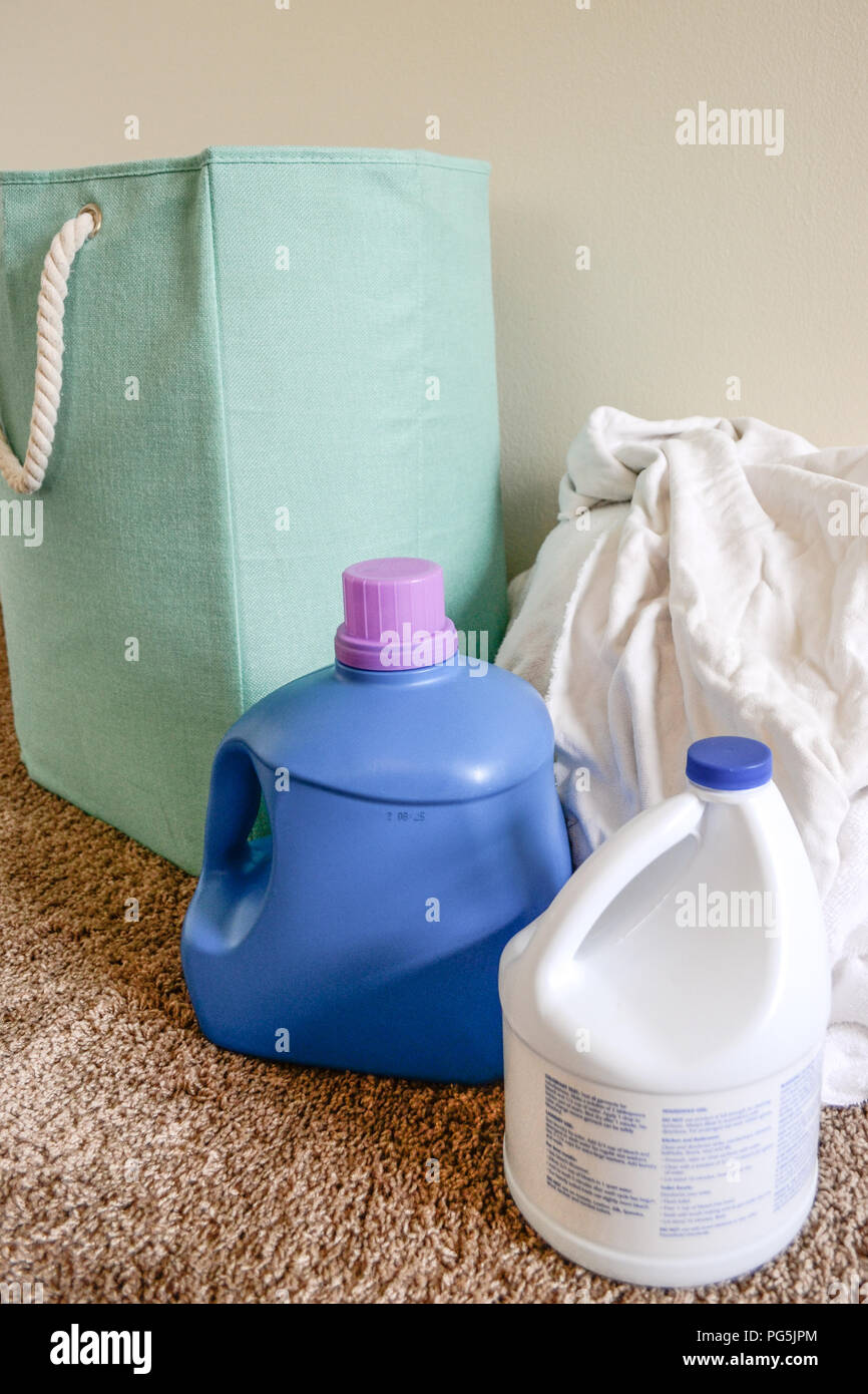 Laundry day at home. Washing white clothes and towels with bleach and laundry detergent. Stock Photo