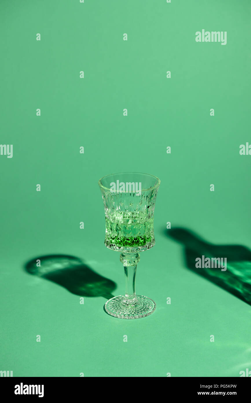 close-up shot of lead glass of absinthe on green surface Stock Photo