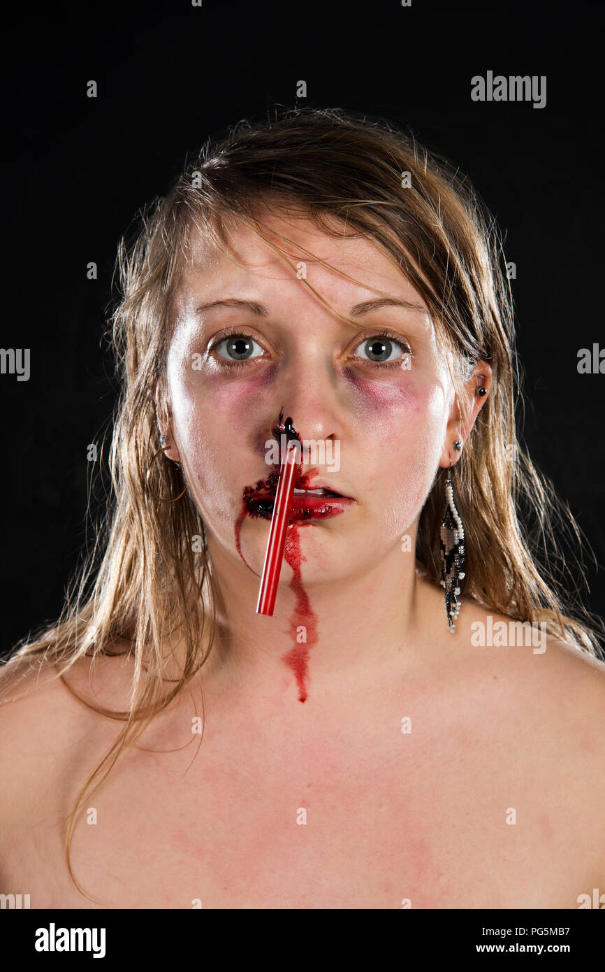Plastic in the Ocean Horror Piece - Blood / Gore / Plastic straw up a girl's nose Stock Photo