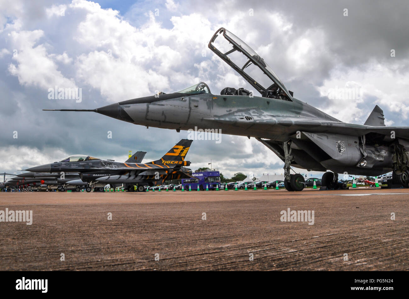 Jet fighter planes at the Royal International Air Tattoo RIAT RAF Fairford, UK. MiG 29, F-16s. Line of planes. Fighters. Multinational Stock Photo