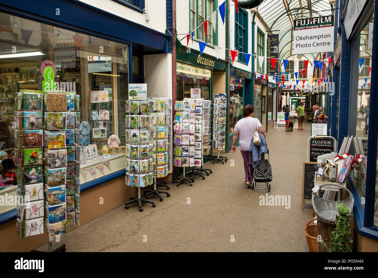 UK, England, Devon, Okehampton, Fore Street, shoppers in Victorian glazed shopping arcade Stock Photo