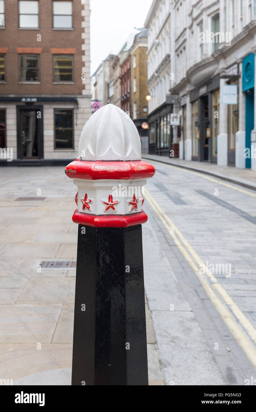 Black pillar with red and white top in the City of London to protect pedestrians and prevent vehicles parking on the pavement Stock Photo