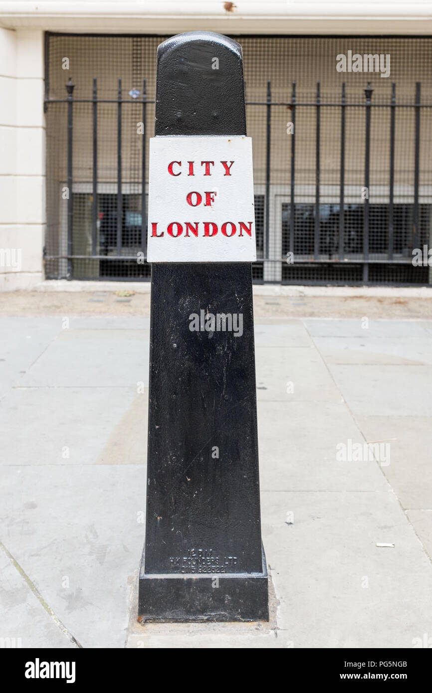 Black pillar with red and white top in the City of London to protect pedestrians and prevent vehicles parking on the pavement Stock Photo