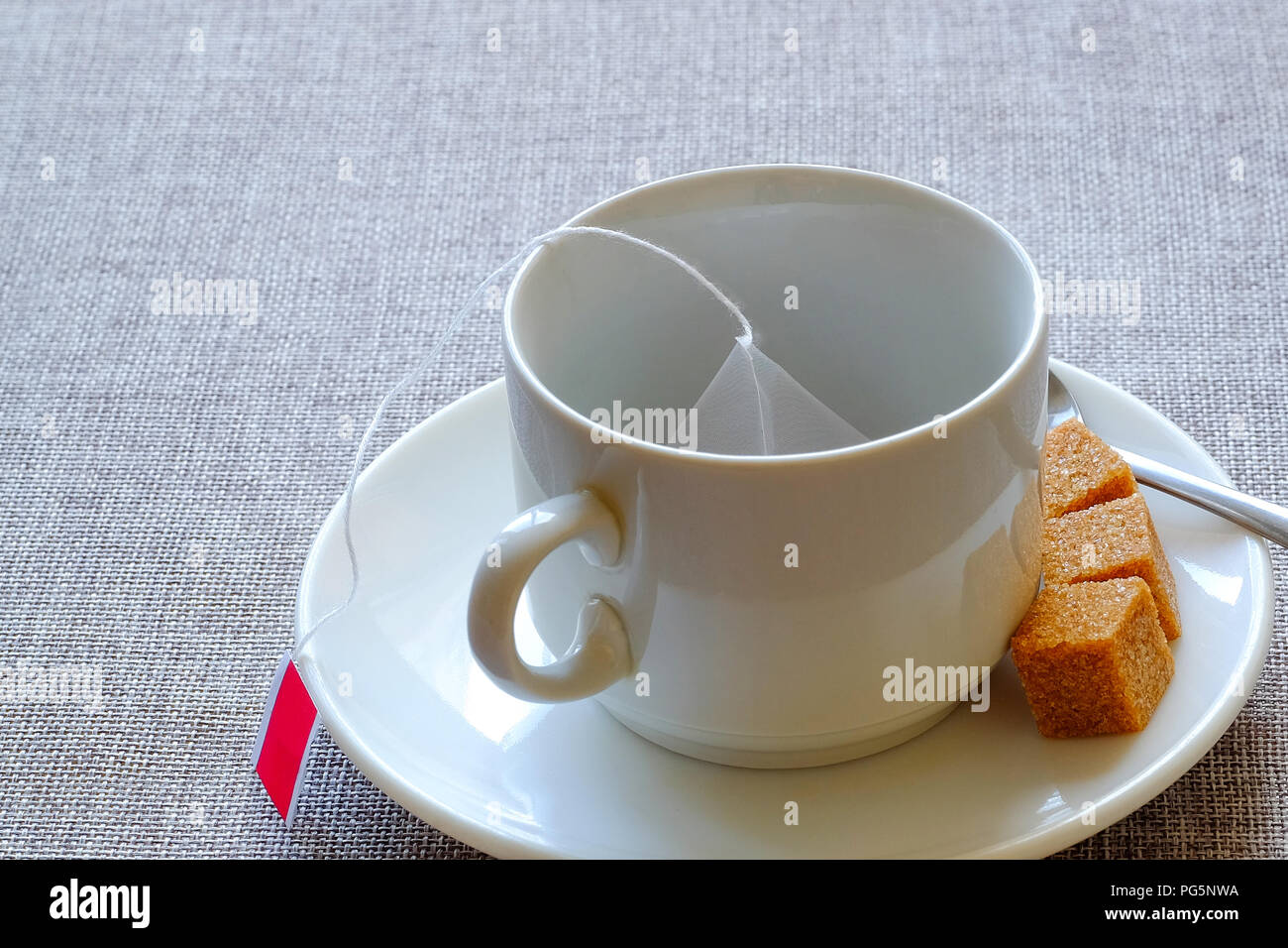 Teacup. Cane sugar, fruit tea in a bag. Aerial view of an empty Cup of
