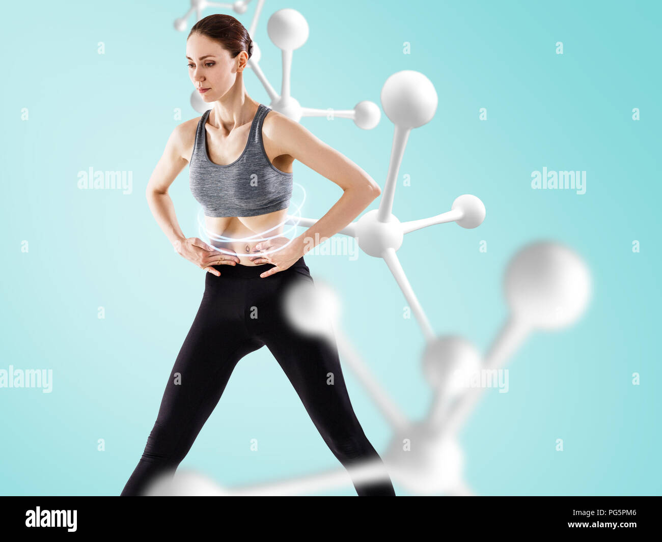 Young woman doing vacuum exercise near white molecule chain. Stock Photo