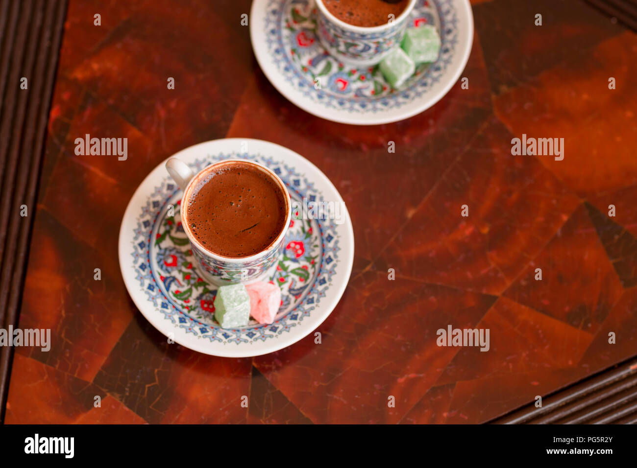 Two traditional porcelain Turkish coffee cups with Turkish delight on a ...