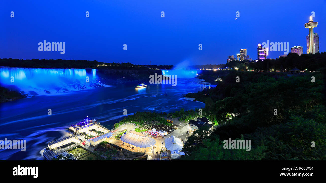 Horseshoe and American Falls, river and Niagara skyline illuminated at night, panoramic view, Canada Stock Photo