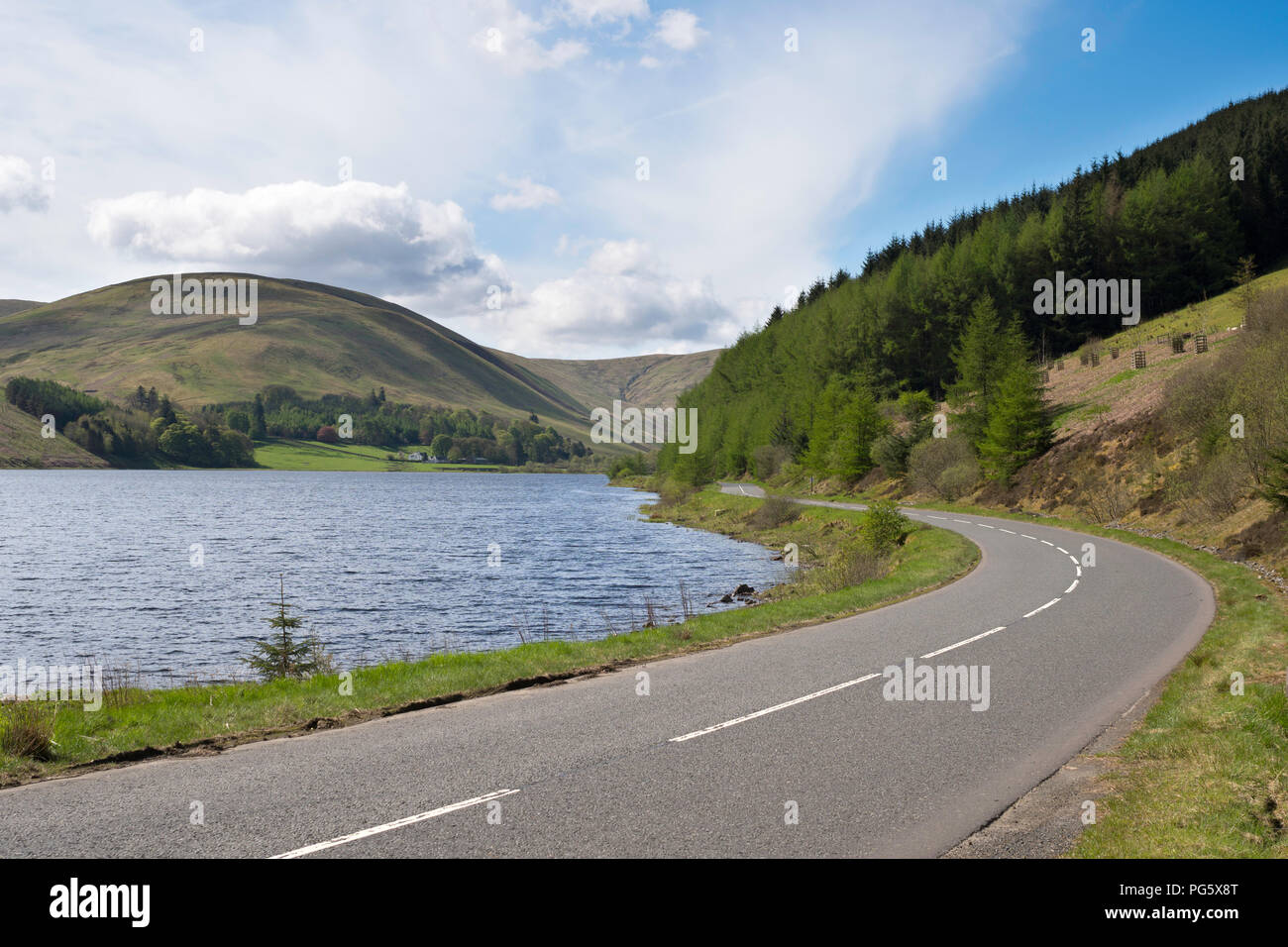 The empty A708 road beside Loch of the Lowes between Moffat and Selkirk, Scottish Borders, Scotland, UK Stock Photo