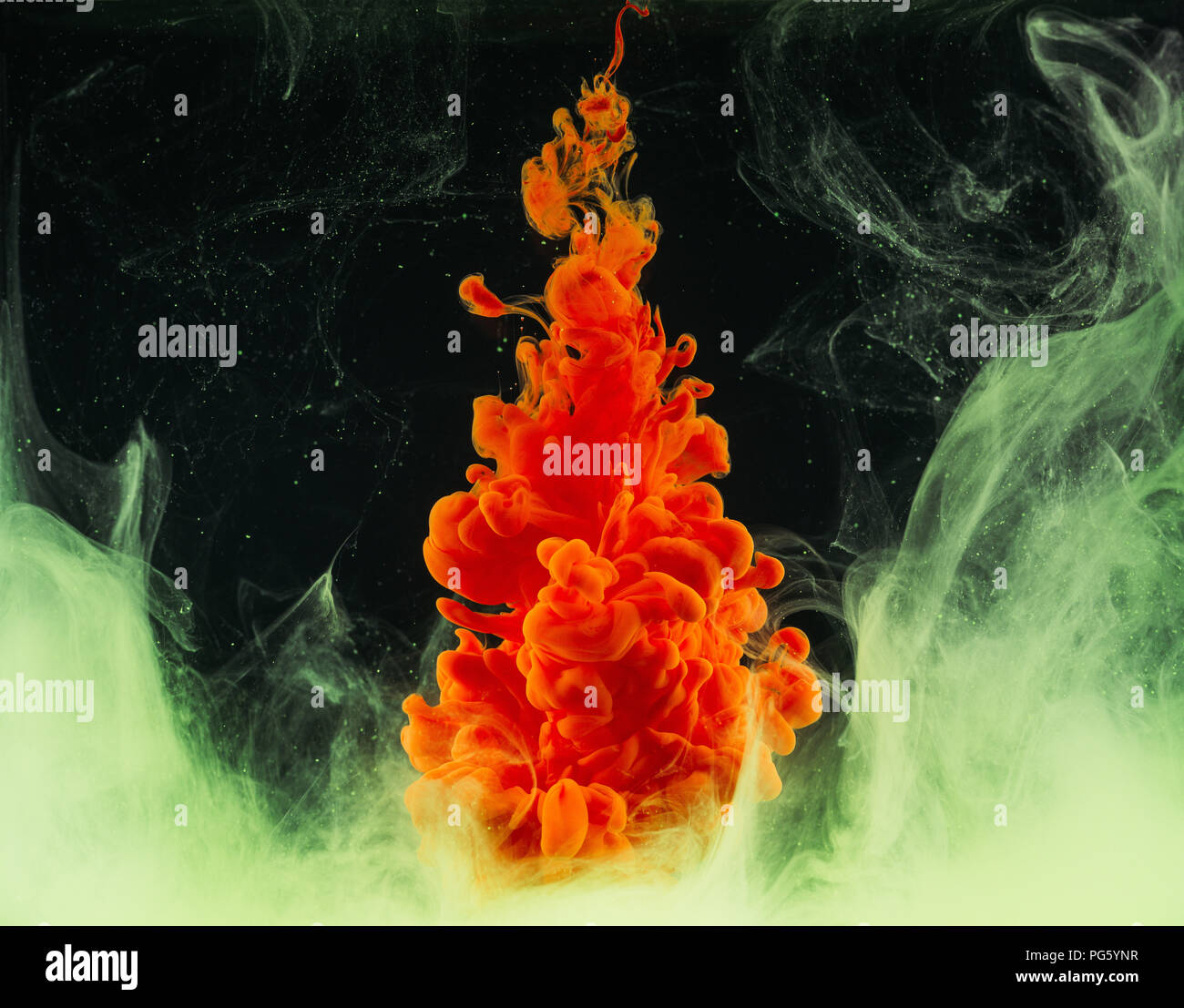 close-up view of bright abstract orange paint explosion on black Stock ...