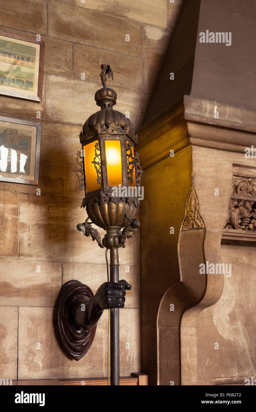 A light holder like a man's arm in Bamburgh Castle, Northumberland, England, UK Stock Photo