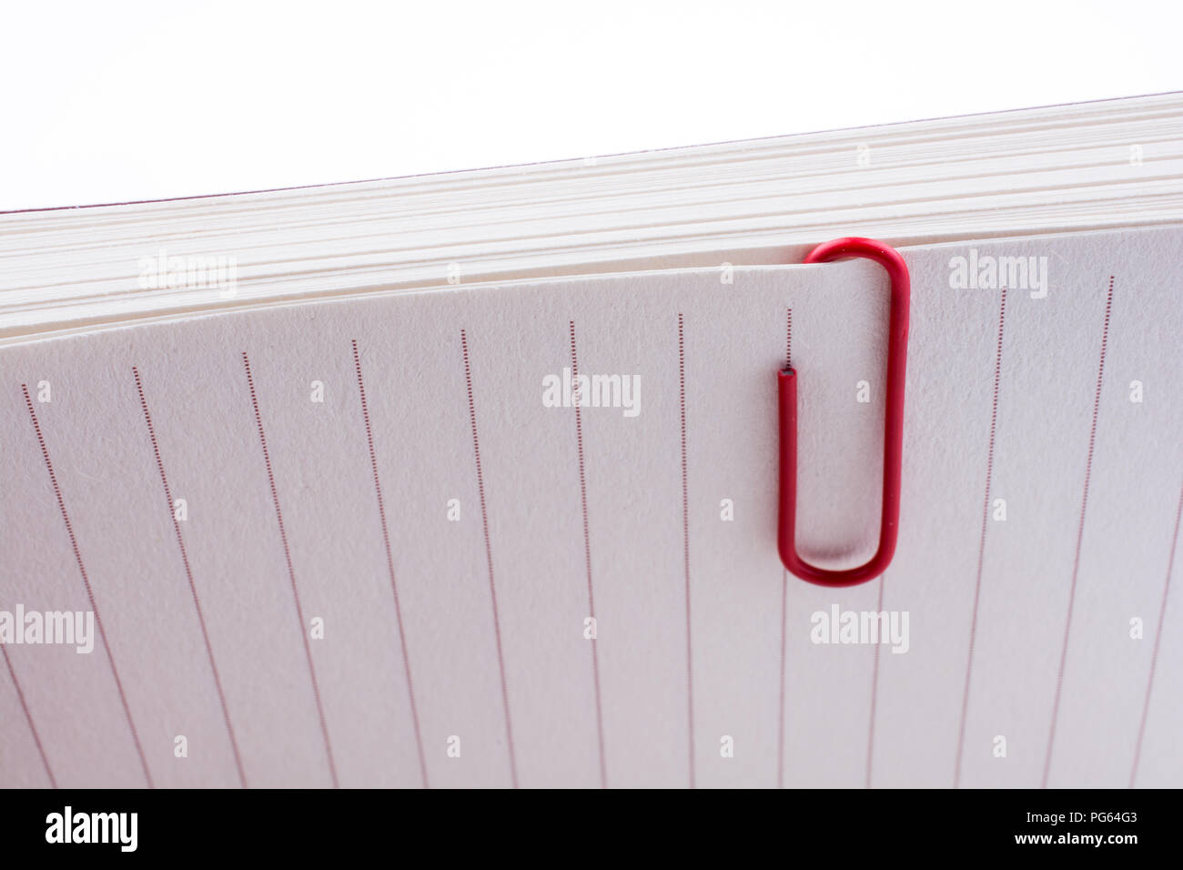 Colored paper clip on a checked notebook page Stock Photo