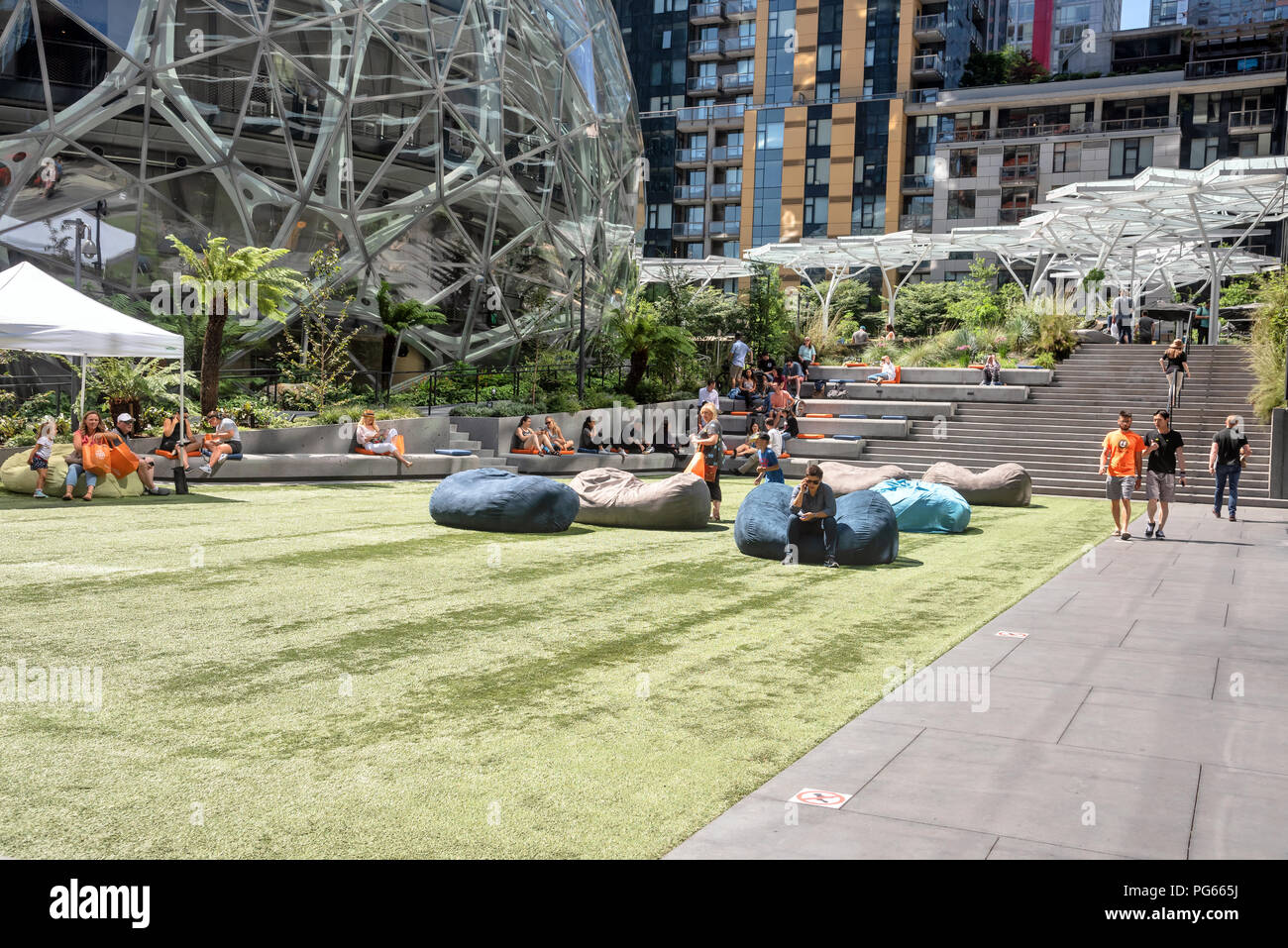 Amazon employees rest on the campus of the headquarters of Amazon ...