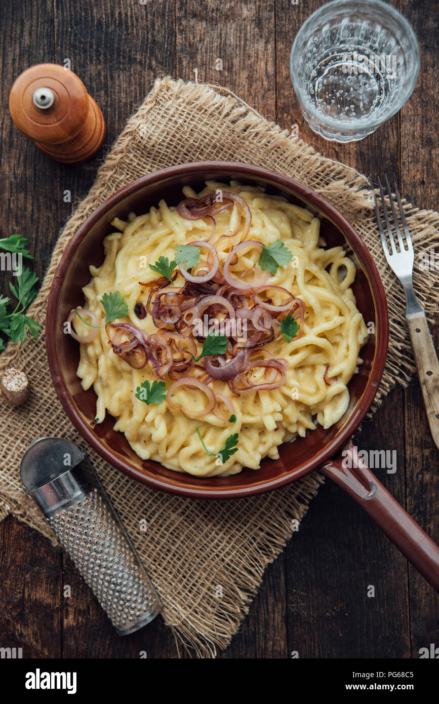 Traditional swabian 'Käsespätzle', german dish, egg noodles with cheese, cream, roasted onions Stock Photo