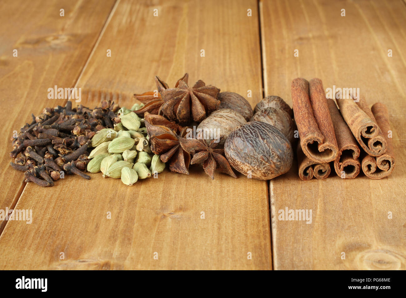 Pile of dry spice cloves, pile of dry scattered unrefined cardamom