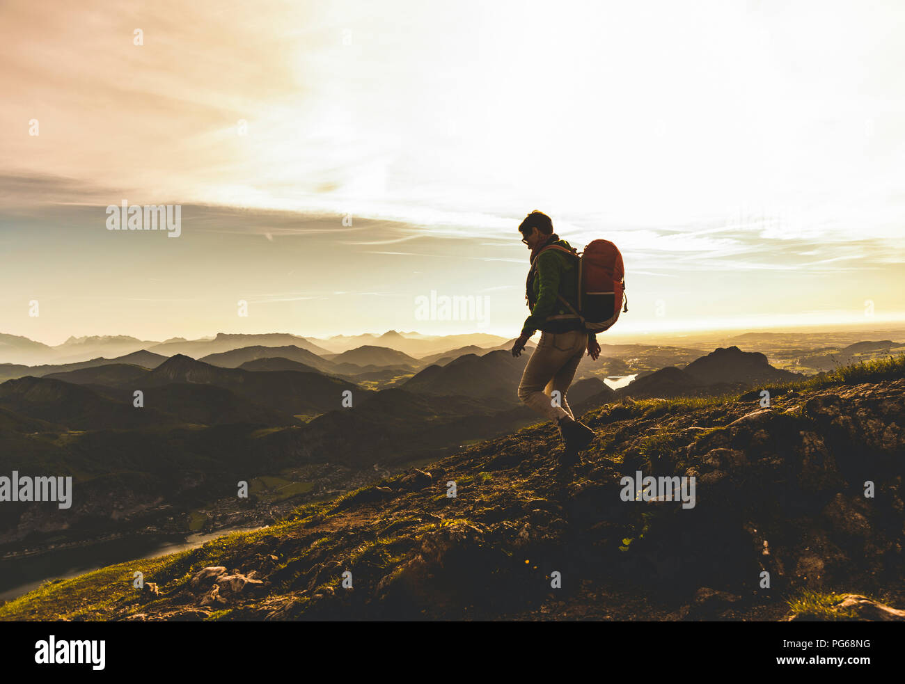 Austria, Salzkammergut, Hiker with backpack hiking in the Alps Stock Photo