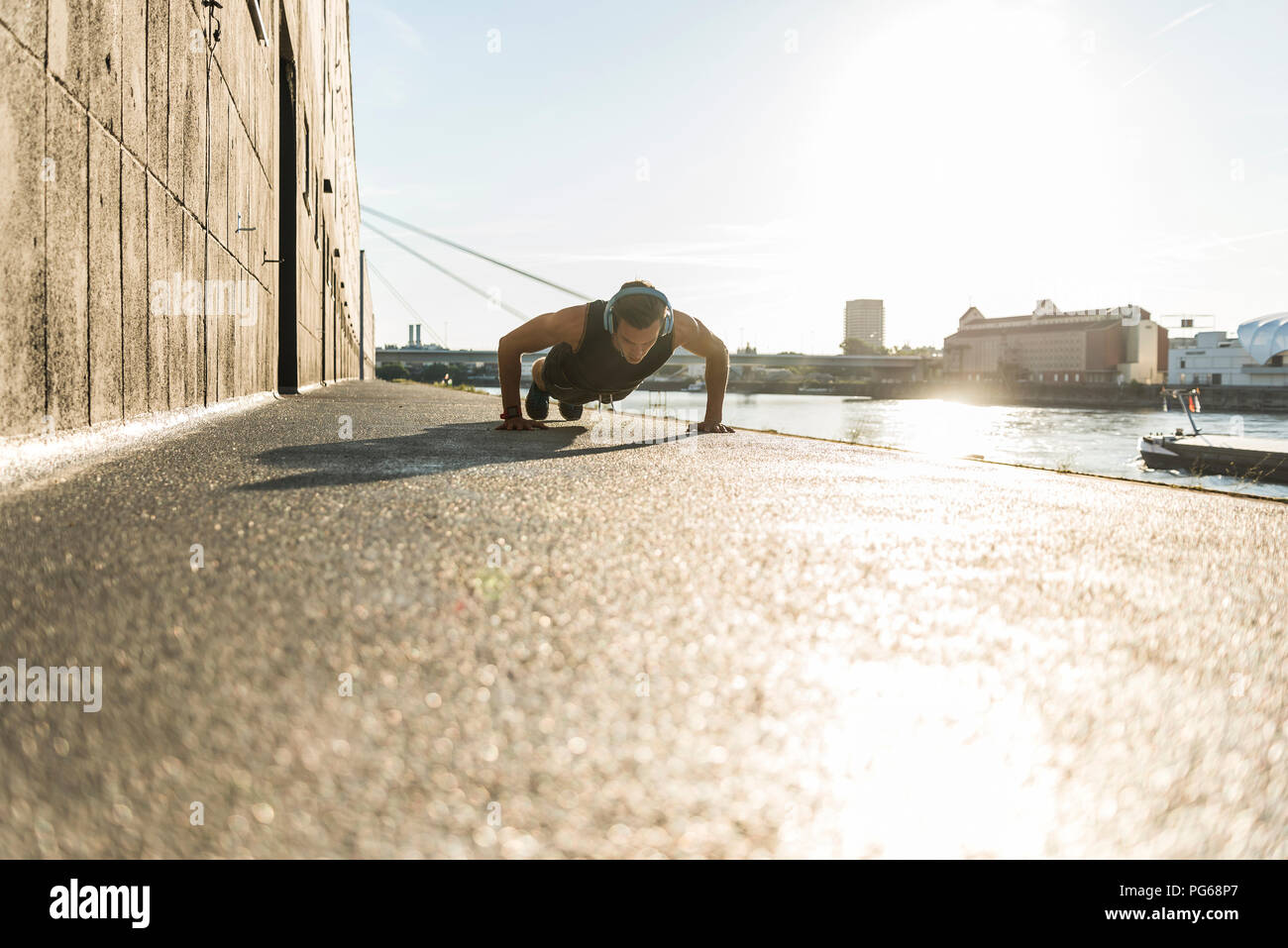 Fit athlete doing push ups at the river Stock Photo - Alamy