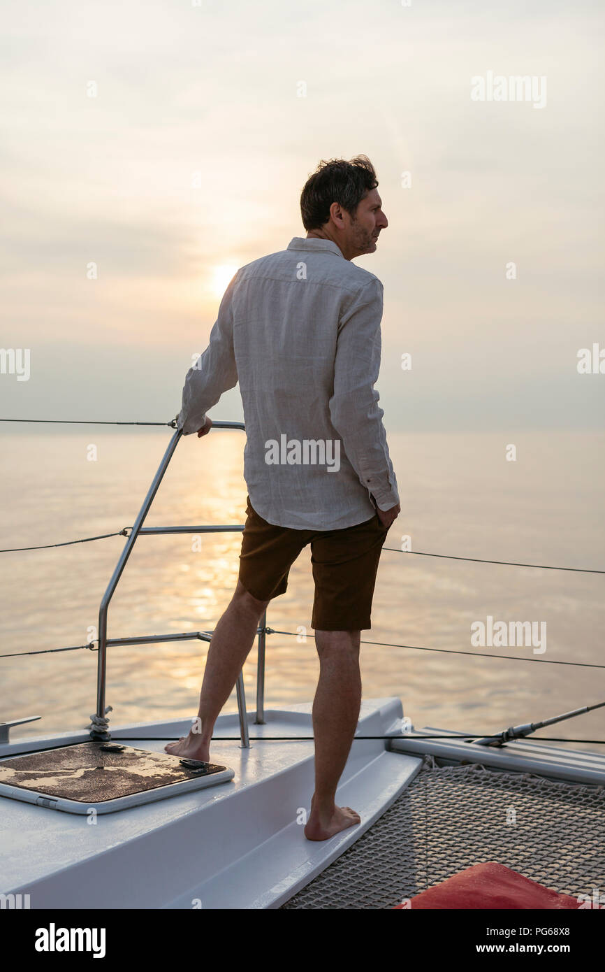 Marure man on catamaran, looking ta view Stock Photo