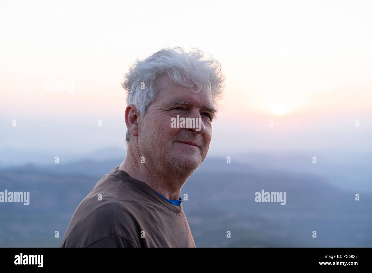 Spain, Catalonia, Man looking at sunset in the mountains Stock Photo