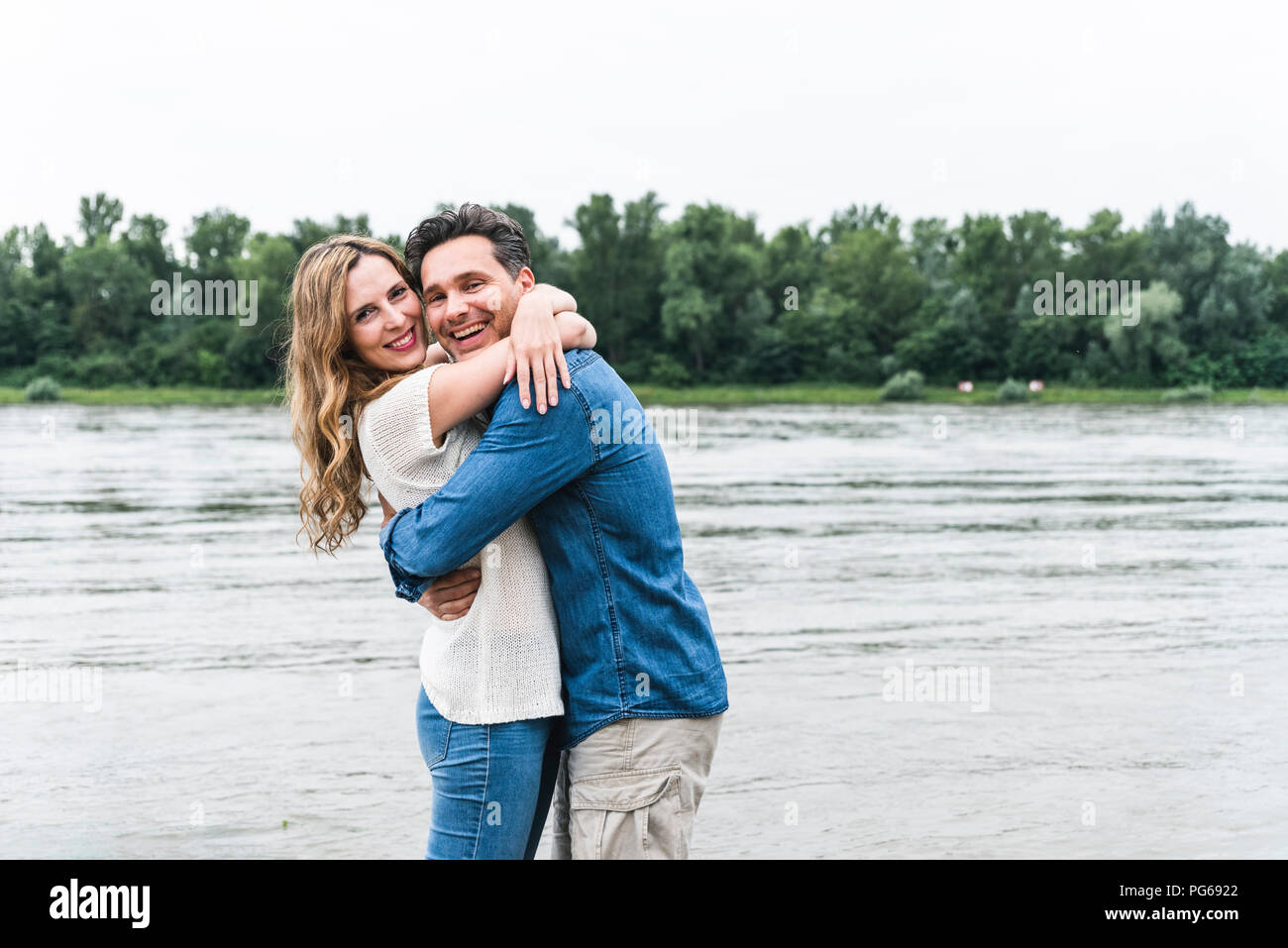 Portrait happy couple hugging hi-res stock photography and images - Alamy