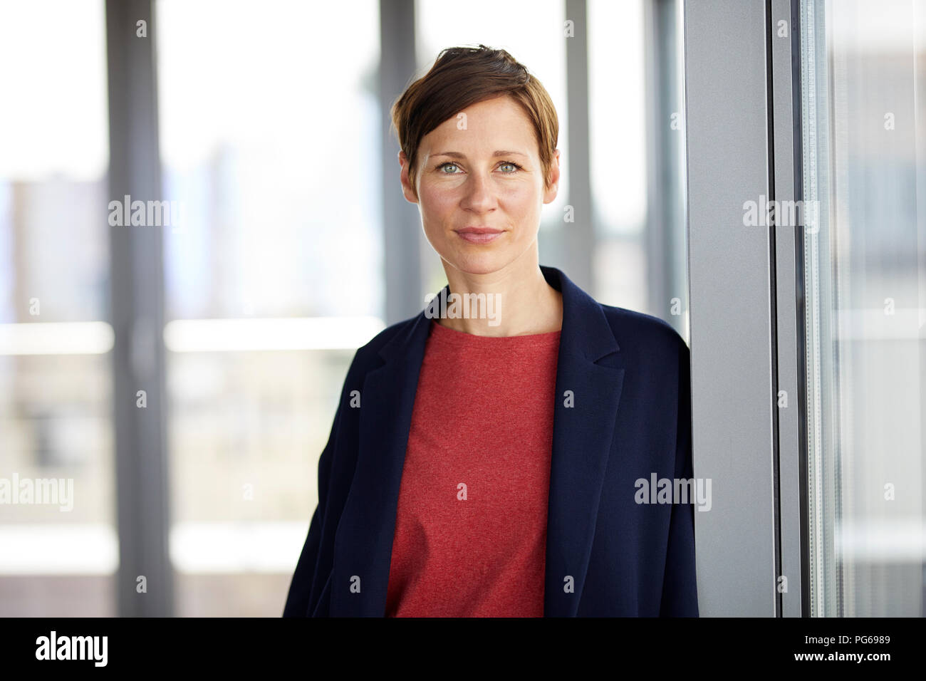 Portrait of smiling woman in office Stock Photo