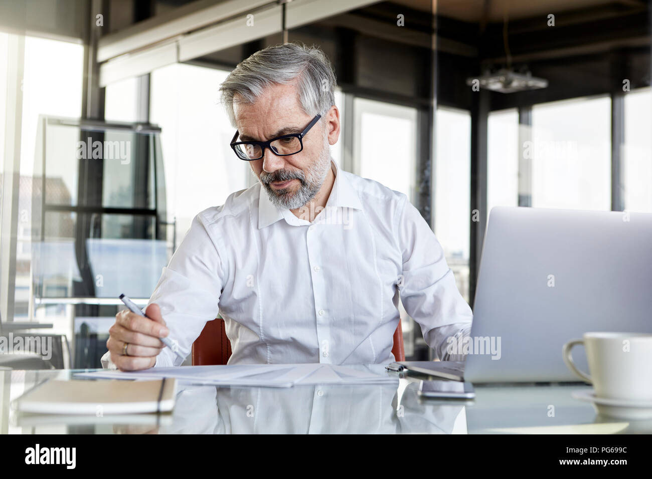 Businessman working at desk in office Stock Photo