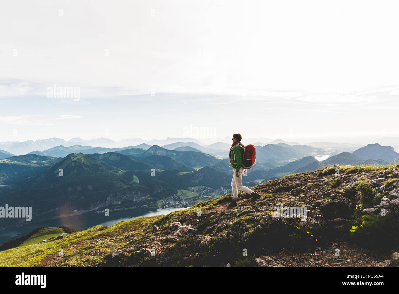 Austria, Salzkammergut, Hiker with backpack hiking in the Alps Stock Photo