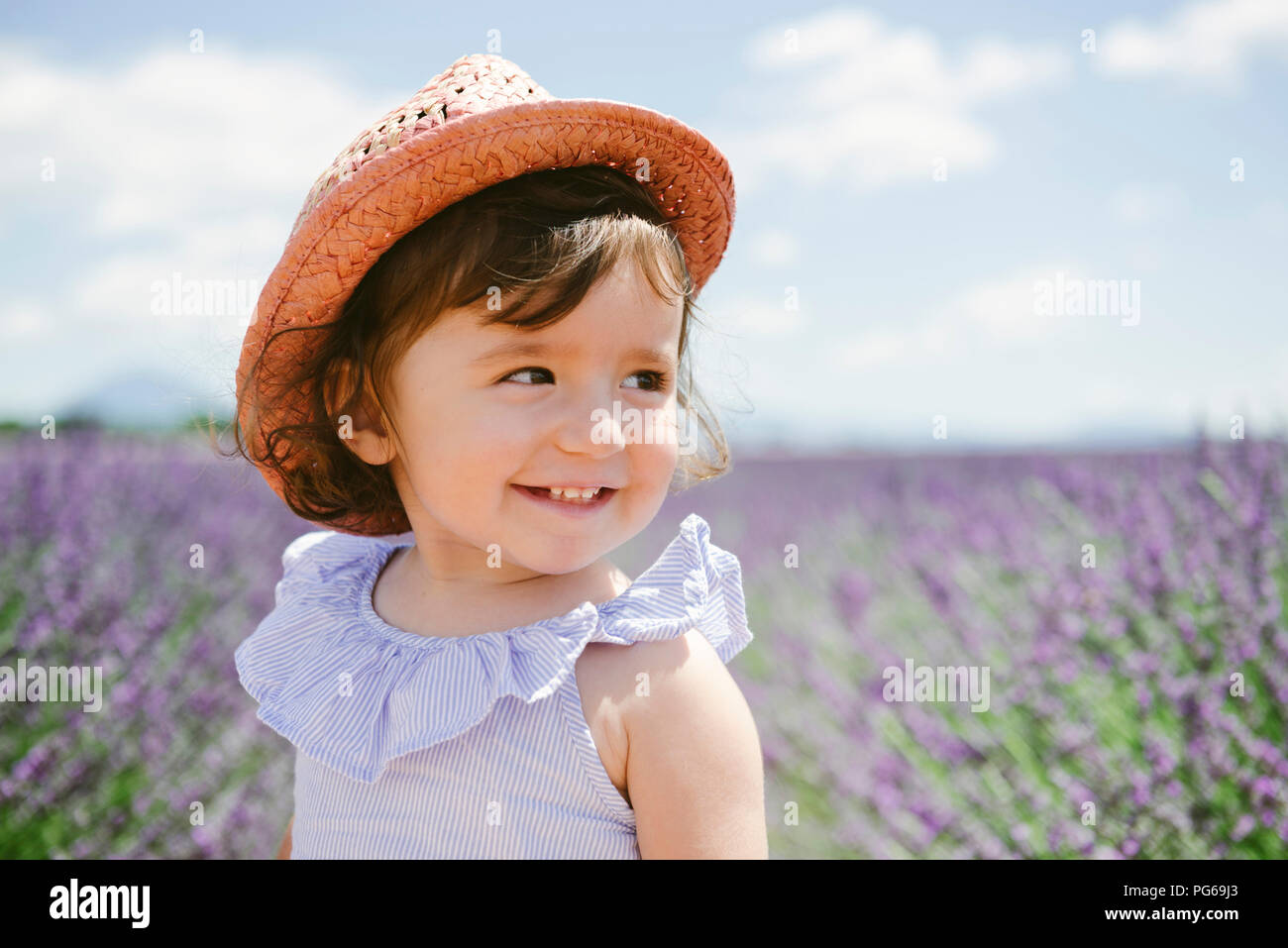 France, Provence, Valensole plateau, Happy toddler girl in purple lavender fields in the summer Stock Photo