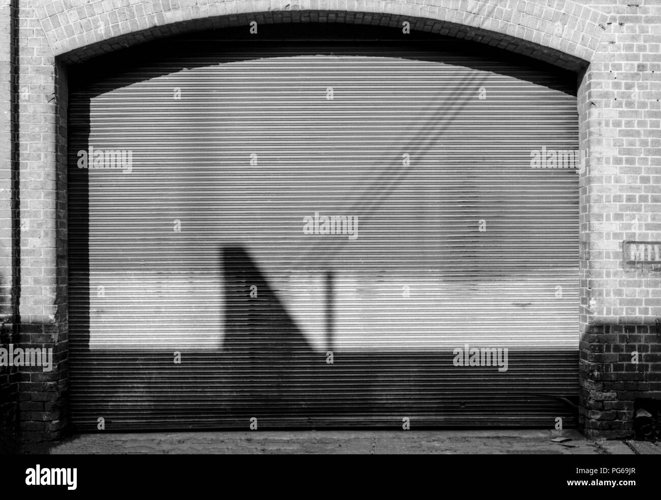 A cast of shadows: Reflected shapes on a garage door. Stock Photo