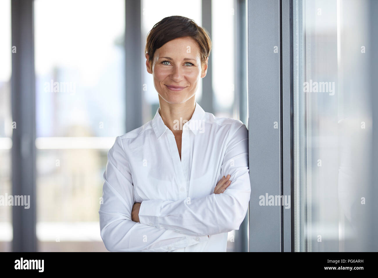 Portrait of smiling businesswoman in office Stock Photo