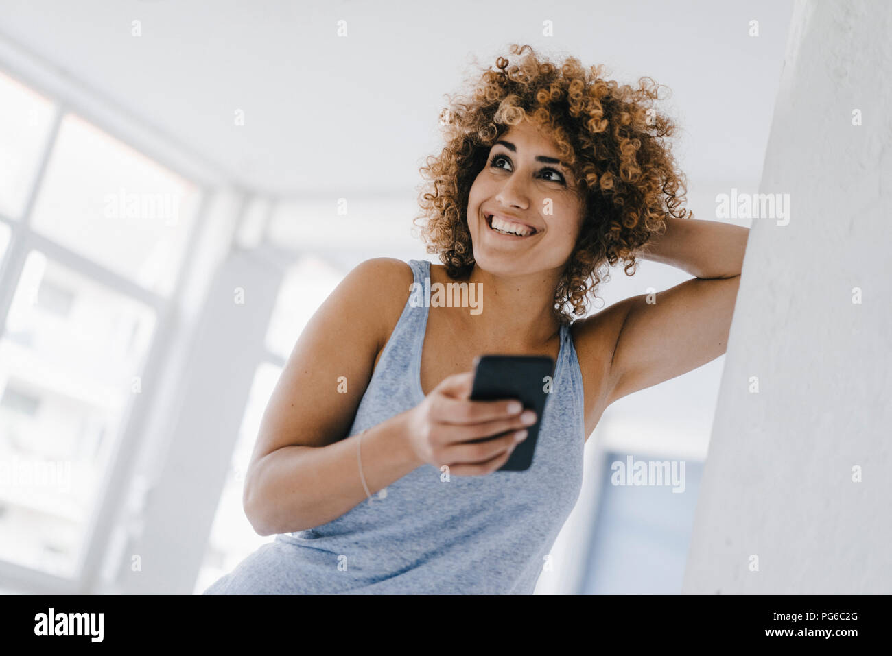 Laughing woman using smartphone Stock Photo