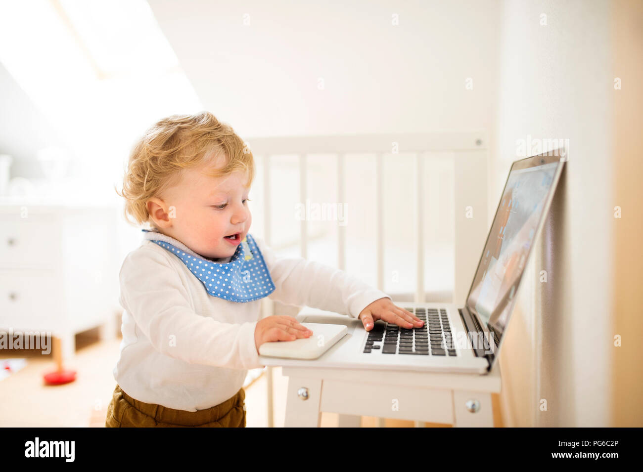 Little boy at home playing with laptop Stock Photo - Alamy