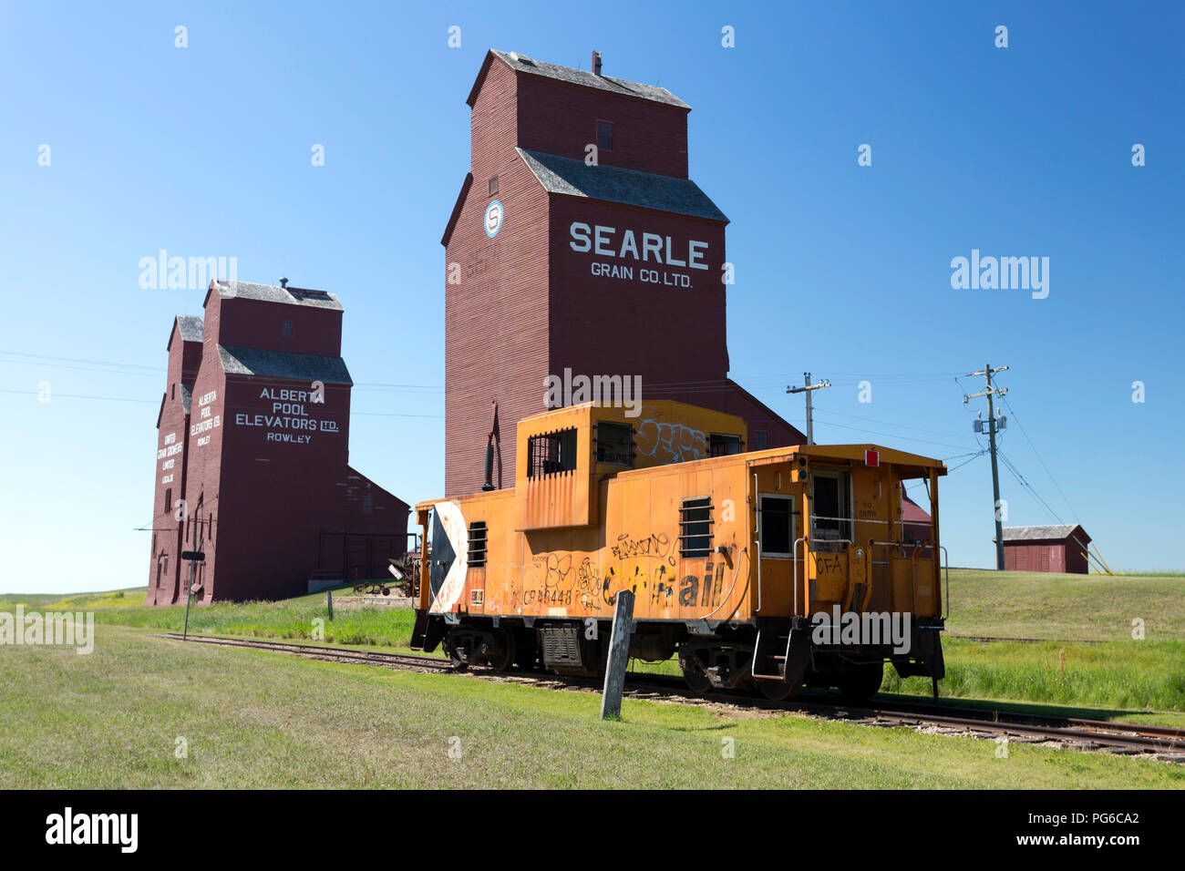 July 13, 2018 - Rowley, Alberta, Canada: Old weathered wood grain elevators in the small Canadian prairie town of Rowley, Alberta, Canada. Stock Photo