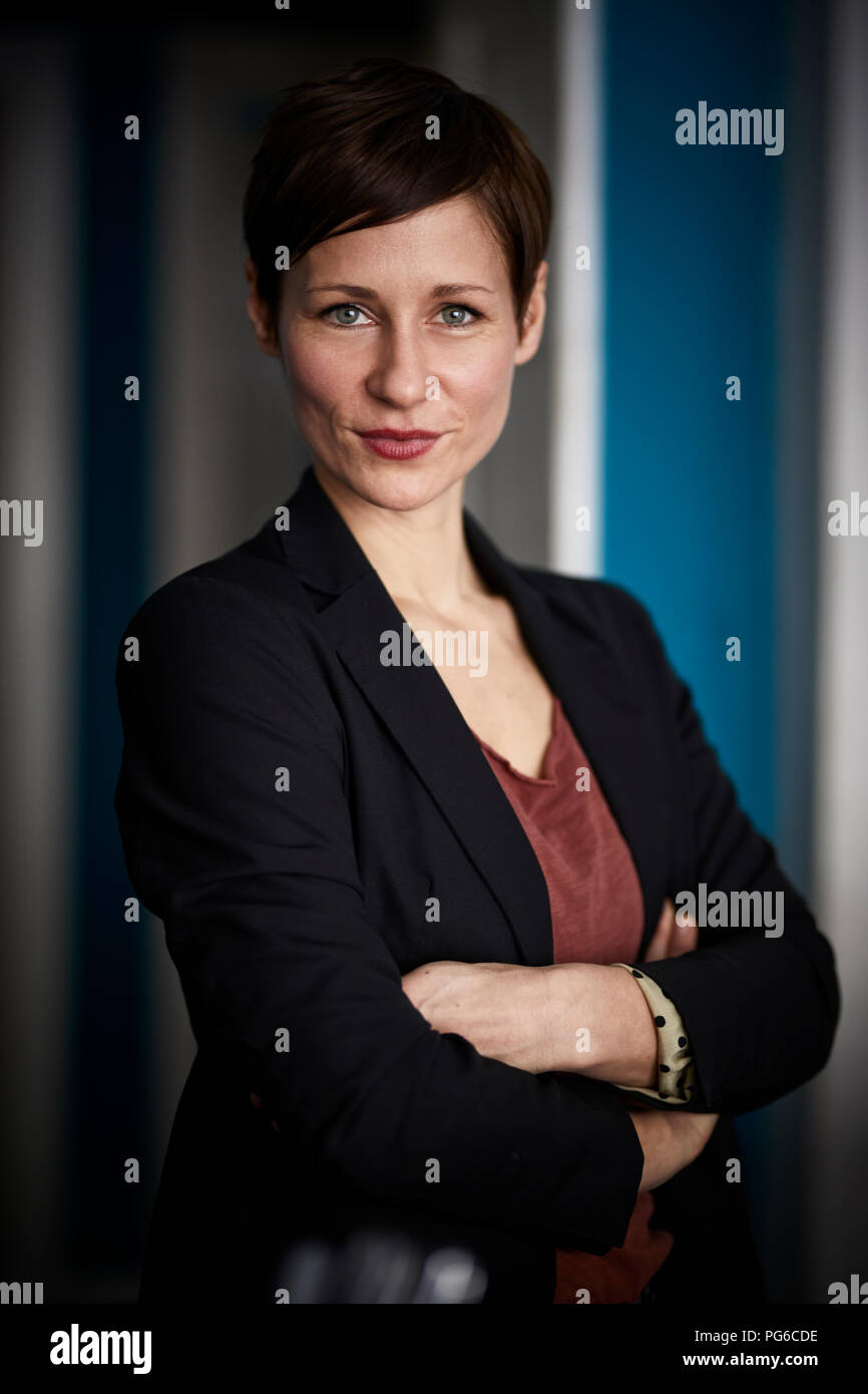 Portrait of a businesswoman leaning in door Stock Photo