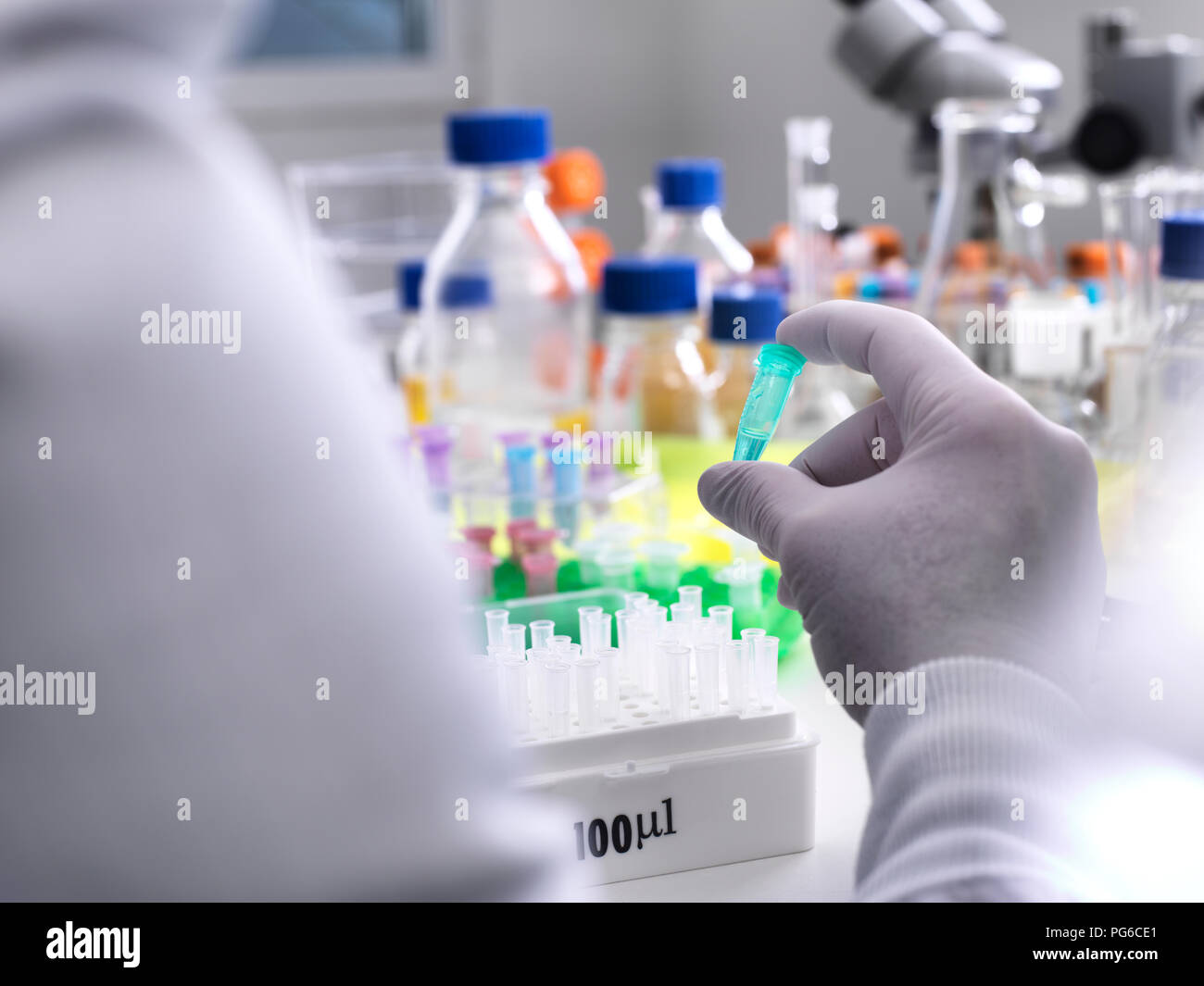 Scientist viewing specimens vial during experiment laboratory hires