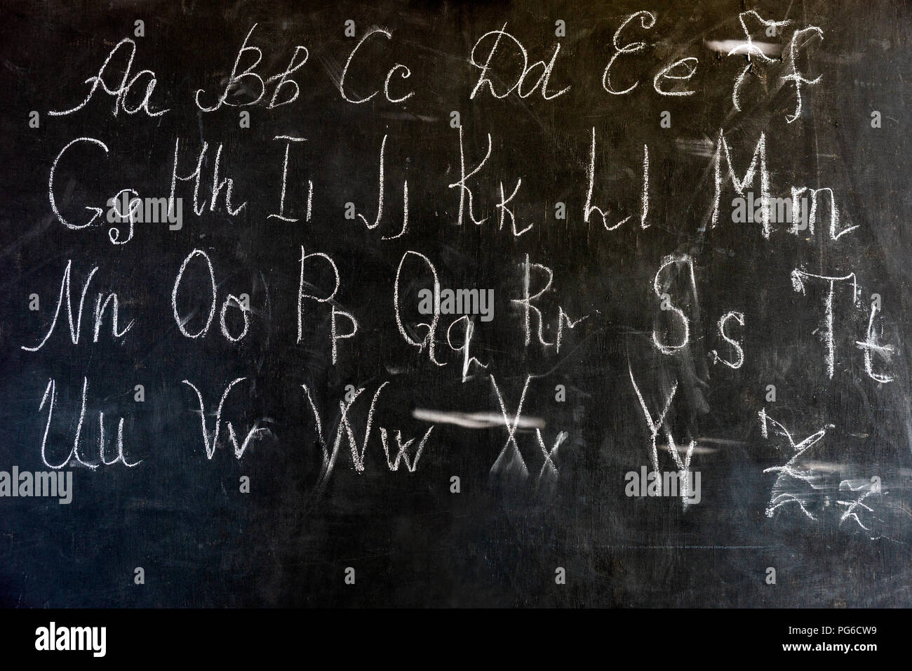 English alphabet written with a piece of chalk on a vintage black board. Back to school, education theme Stock Photo