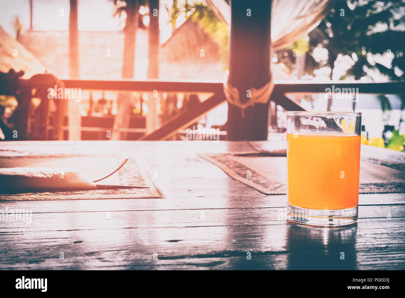 Healthy drinking orange juice in the morning vintage retro tone with