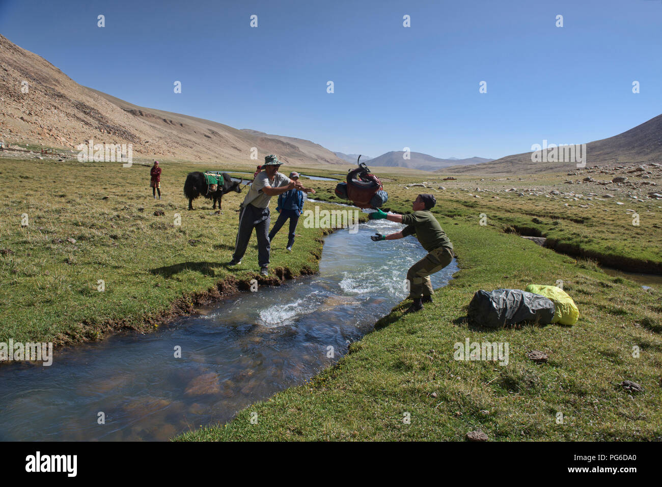 Getting packs across the river while trekking to Lake Zorkul, Tajikistan Stock Photo