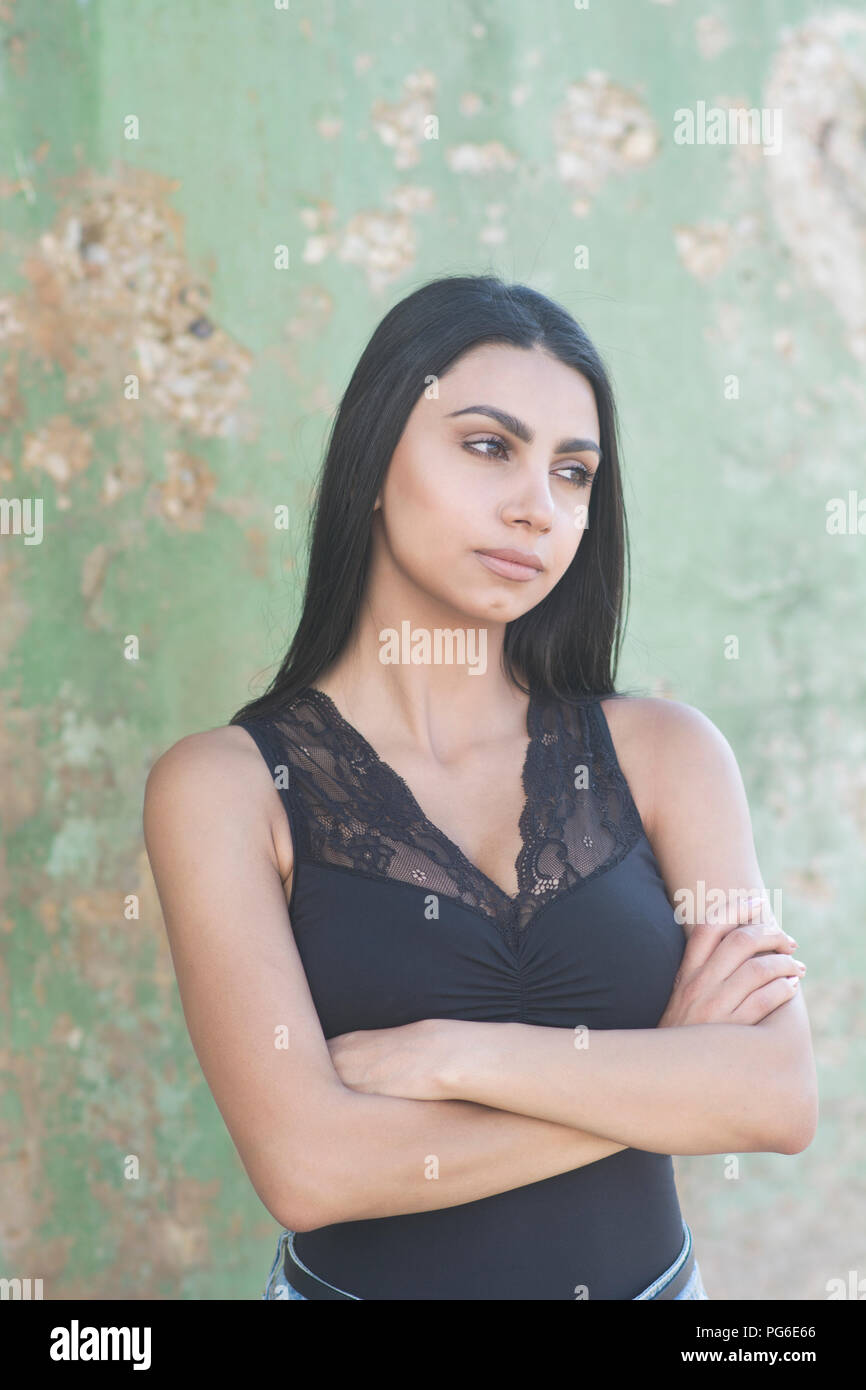 Beautiful Young Woman Arms Folded Looking Away Outdoors Stock Photo Alamy