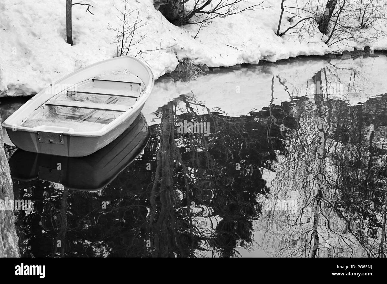 Boat on the still water in the mild winter, black and white Stock Photo