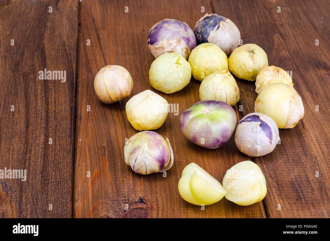 Ripe tomatillo (Physalis, Mexican husk tomato) on wooden table. Studio