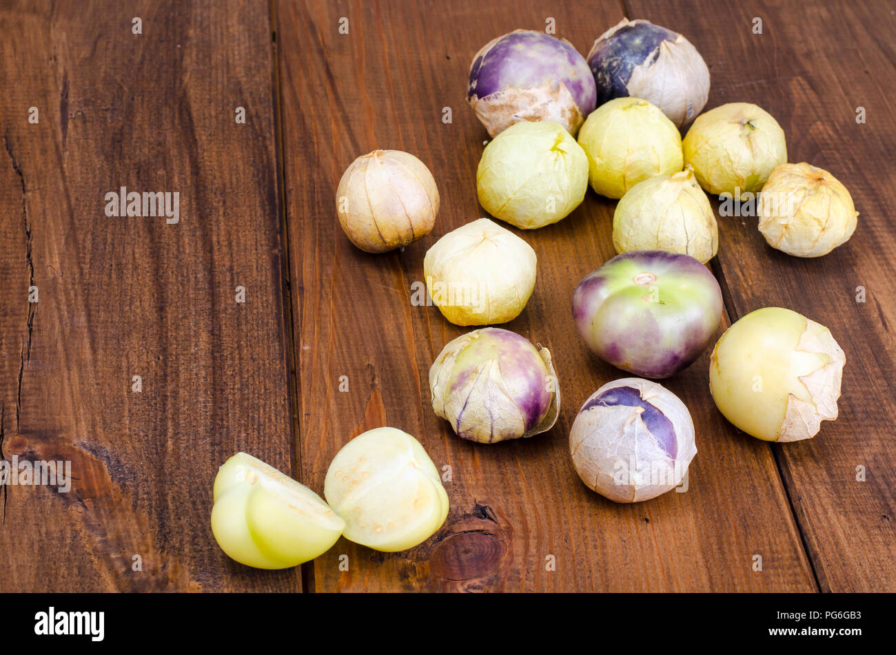 Ripe tomatillo (Physalis, Mexican husk tomato) on wooden table. Studio Photo Stock Photo