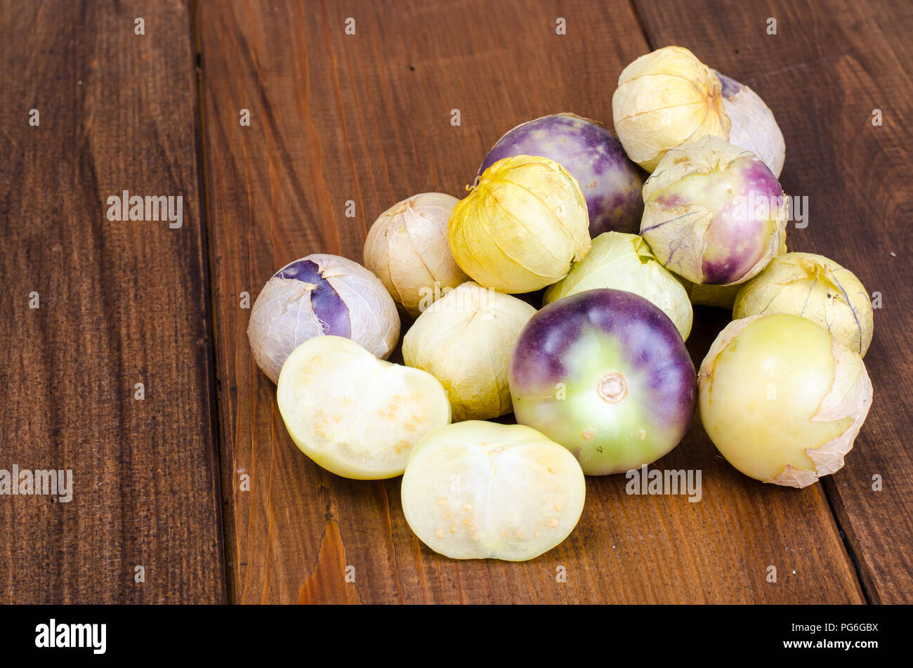 Ripe tomatillo (Physalis, Mexican husk tomato) on wooden table. Studio Photo Stock Photo