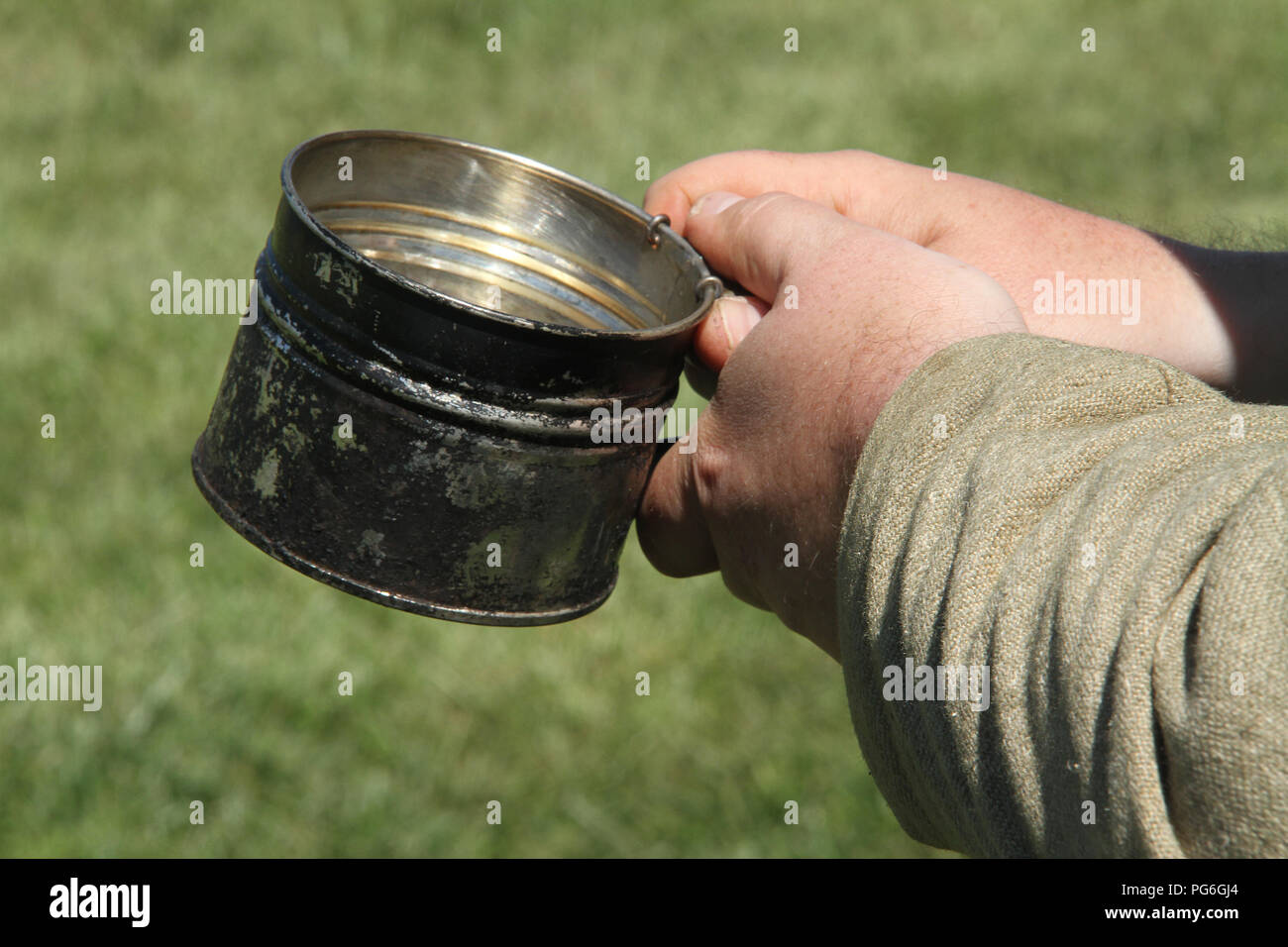 The Confederate Army camping during the American Civil War. Soldier having a drink. Historical reenactment at Appomattox, VA, USA. Stock Photo