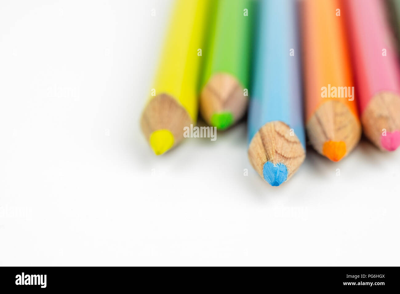 Close up selective focus of colorful color pencil stacked on white background. Ideal for back to school, education and business abstract background co Stock Photo